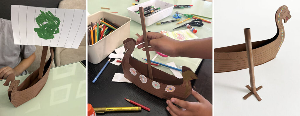 Students testing different ways to make the paper mast stand upright on a 3D Viking longship art project